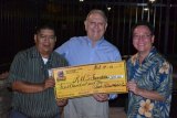 Bill Black (center) receives a check from the Tachi Palace's Willie Barrios former Tiger George Will looks on.